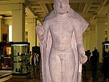 British Museum Top 20 Buddhism 06 Standing Buddha From Sarnath 6. Standing Buddha - Sarnath India, about 435AD, 1.44m high. This sandstone sculpture has heavy lidded eyes and a gentle smile marked by a pronounced lower lip, set in an oval head with heavy cheeks. This image wears a characteristically clinging garment. He holds his right hand in the fearless mudra. He has the cranial protuberance, elongated earlobes, and long arms.